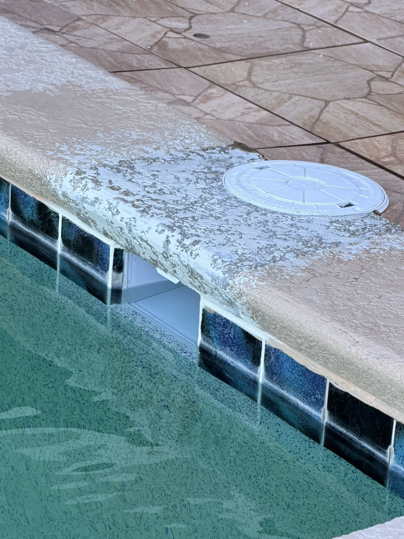 New concrete capstone coping poured over the replaced skimmer — Daytona Beach, FL