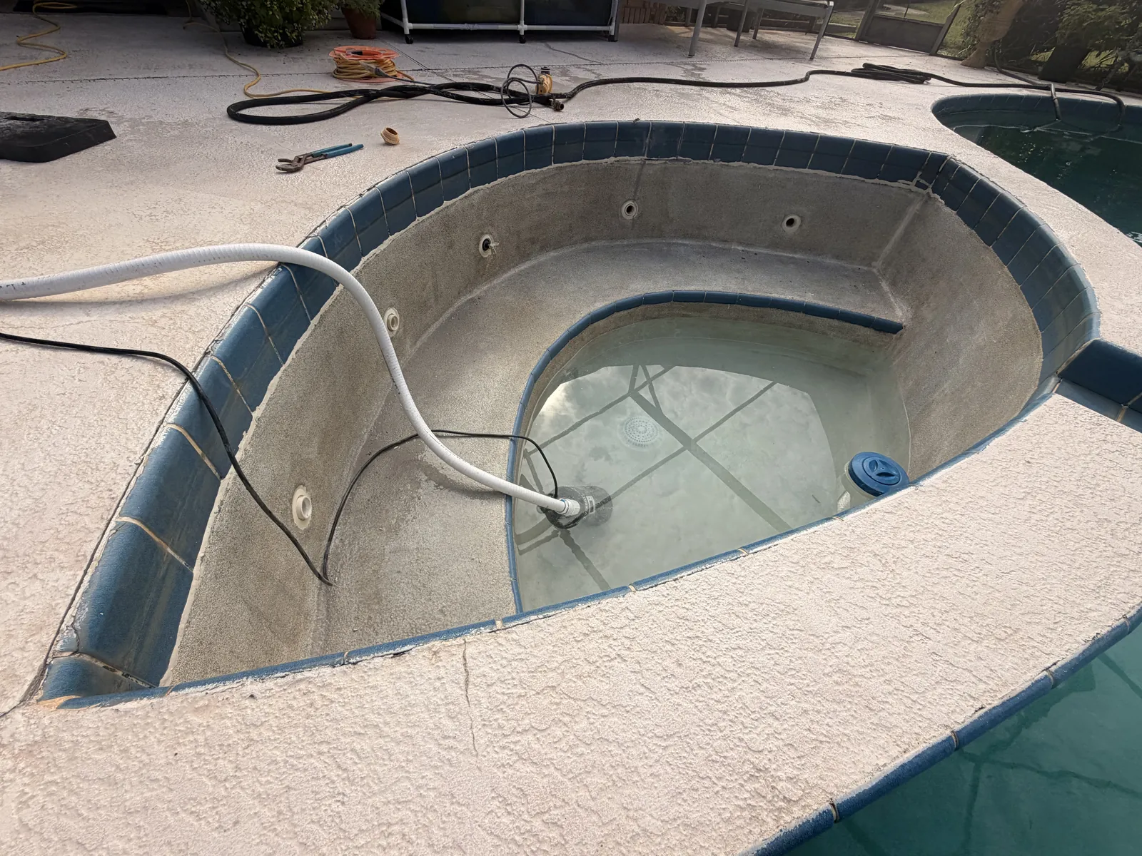 Drained spa with a leaking tile line along its outer bond beam — Deltona, FL