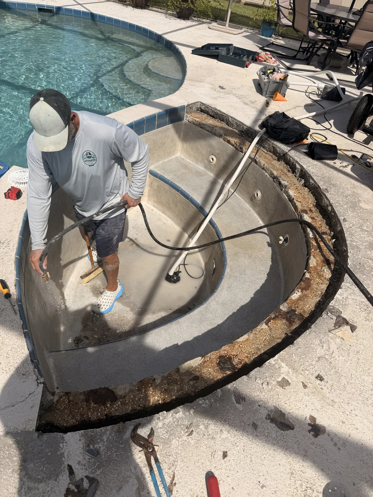 Deteriorated concrete removed along the full length of the spa bond beam — Deltona, FL