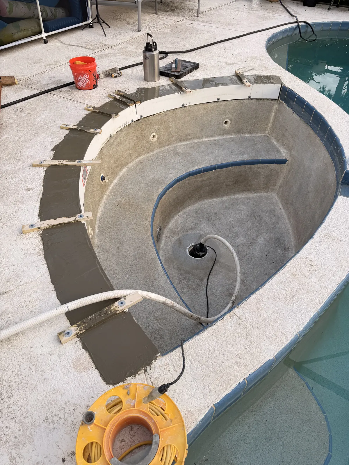 New concrete poured into the forms along the spa bond beam — Deltona, FL