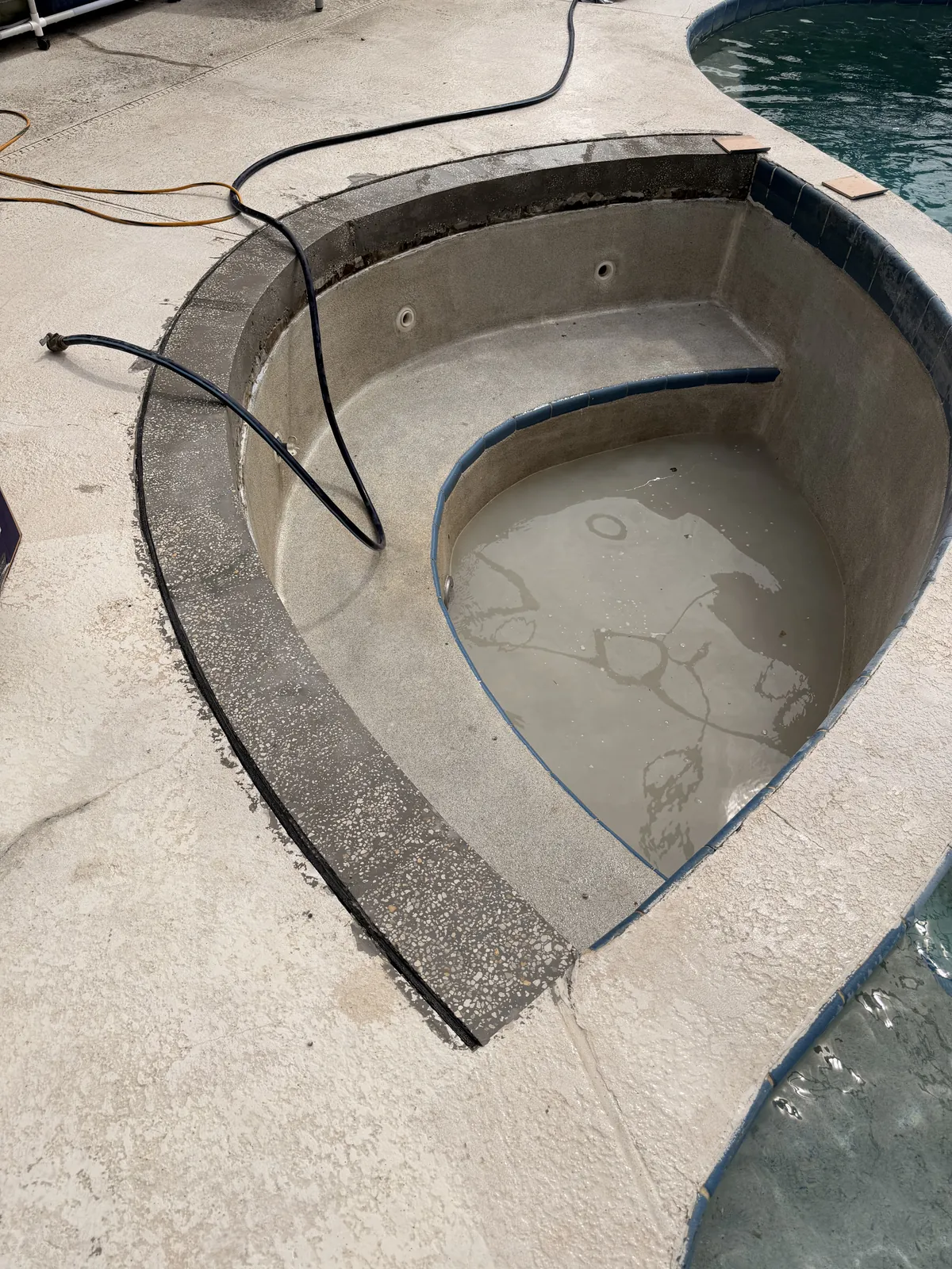 Rebuilt spa bond beam with the forms stripped, ready for tile — Deltona, FL