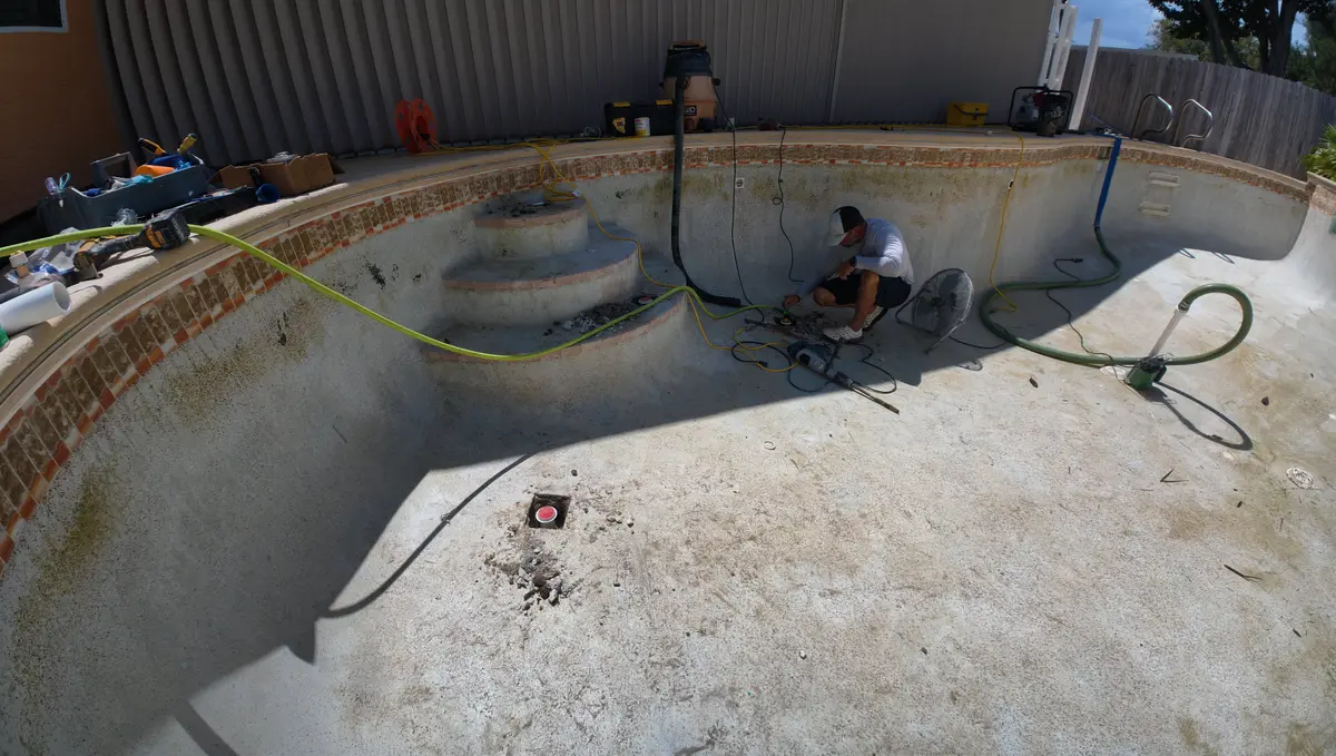 Drained swimming pool with the floor jet repairs under way — Ormond Beach, FL