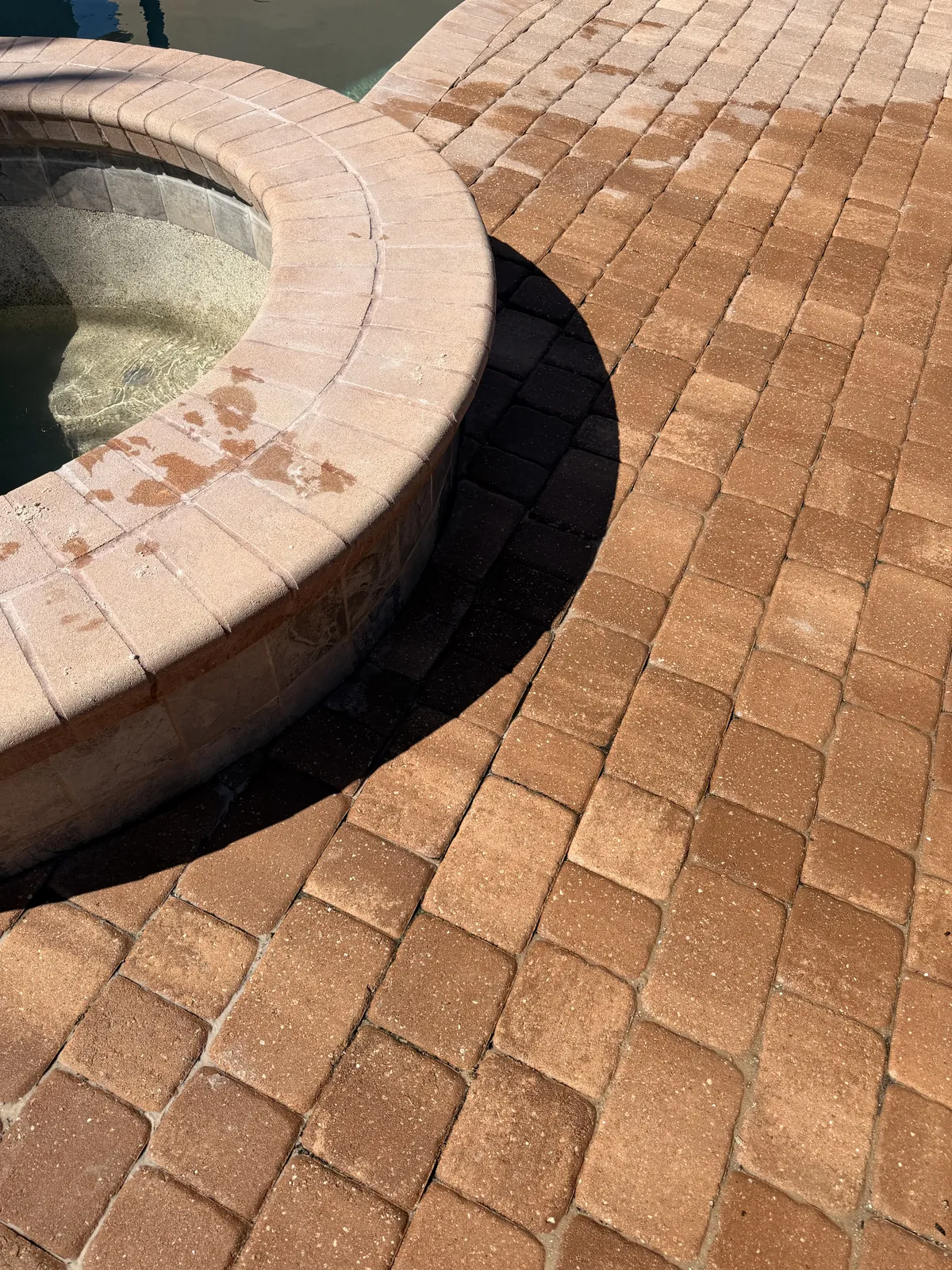 Paver deck reset around the spa after the therapy jet pipe repair — Palm Coast, FL